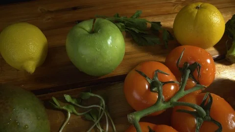 Vegetables on wood. Apple, lemon, mango, sprouted sunflower seeds, tomatoes Video stock 107670979
