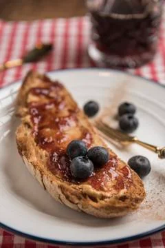 Vegetarian breakfast, toasted rustic bread with peanut butter and strawberry jam Stock Photos