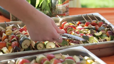 Vegetarian food close up hands serving skewer at a community event Stock Footage 82229073