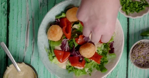 Vegetarian meals: chef finalizes vegetable salad with cheese balls, 4k Video stock 219920640