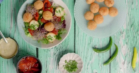 Vegetarian meals: chef puts vegetable salad with cheese balls into the frame, 4k Stock Footage 220718139