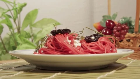 Vegetarian pasta with beetroot sauce, prunes and cheese Stock Footage 70177948