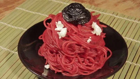 Vegetarian pasta with beetroot sauce, prunes and cheese Stock Footage 70178477