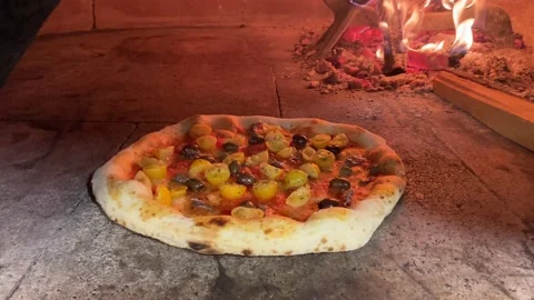 Vegetarian pizza with high crust being cooked in a wood oven. Stock Footage 236479917