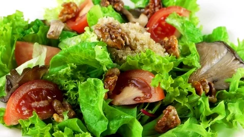Vegetarian quinoa salad with lettuce leaves, oyster mushrooms, close-up Stock Footage 73507853