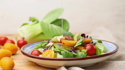 Vegetarian salad of pac choi cabbage poured with oil. Side view, close up. Stock Footage 129777002