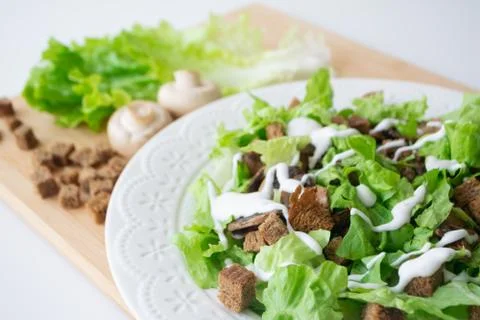 Vegetarian version of classic Caesar salad with mushrooms Stock Photos