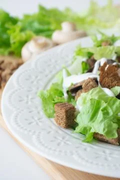 Vegetarian version of classic Caesar salad with mushrooms Stock Photos