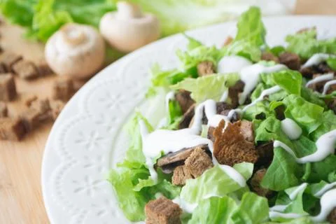 Vegetarian version of classic Caesar salad with mushrooms Stock Photos