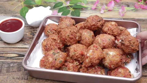 Veggie and hotdogs mashed  balls displaying on table with sauce  Stock Footage 157393659
