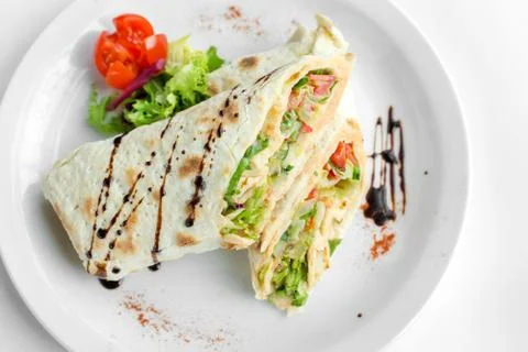 Veggie roll on white plate Stock Photos