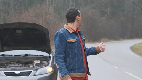 Vehicle breakdown. Young man driver catching help for her broken car Stock Footage 144064671