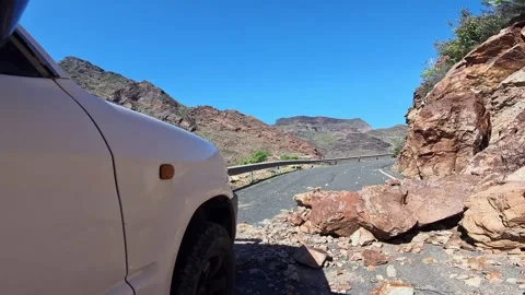 Vehicle cautiously making its way through a treacherous mountain pass road Stock Footage 332975087