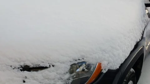 A vehicle is completely buried in a thick layer of snow.  Stock Footage 327685302