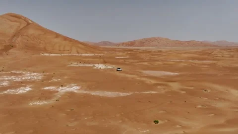Vehicle drives through sand dunes of Empty Quarter, Rub al-Chali in Oman Stock Footage 331665751