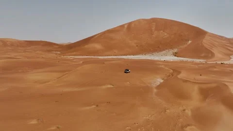 Vehicle drives through sand dunes of Empty Quarter, Rub al-Chali in Oman Stock Footage 331665768