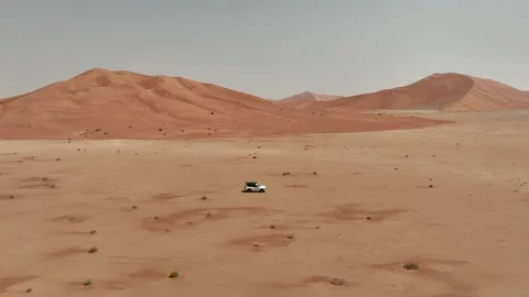 Vehicle drives through sand dunes of Empty Quarter, Rub al-Chali in Oman Stock Footage 331665840