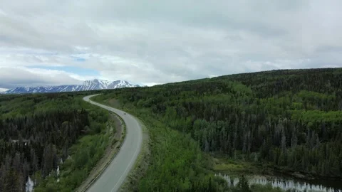 A vehicle driving a windy road, Cloudy day, Aerial View Stock Footage 289565923