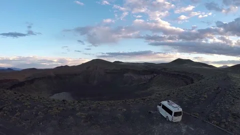 Vehicle on the edge of a massive crater Stock Footage 79813012