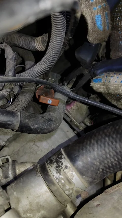 Vehicle engine bay close-up with dirt-covered hoses and metal components Stock Footage 346921515