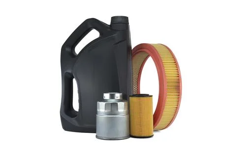 Vehicle engine round air filter, fuel and oil filters near motor oil can Fotos de archivo