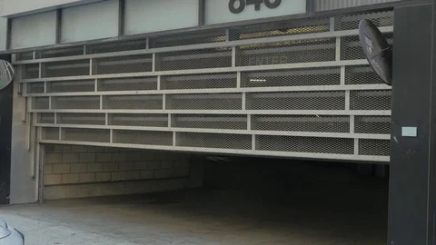 Vehicle entering a secure parking structure. Stock Footage 83115457