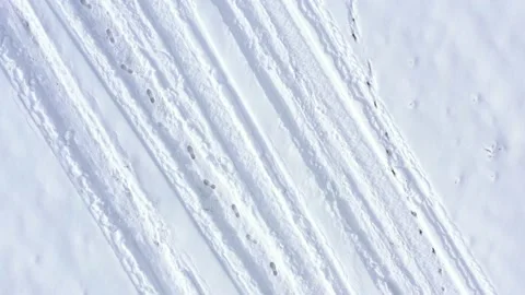 Vehicle marks and foot steps in the snow Stock Footage 101008630