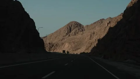 Vehicle moving along an empty mountain highway during a scenic road trip Stock Footage 346248324