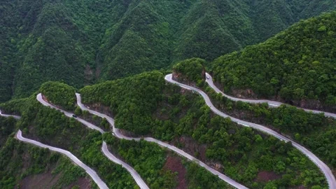 Vehicle Navigating Steep Switchbacks on a Scenic Mountain Pass Road Video stock 341874526