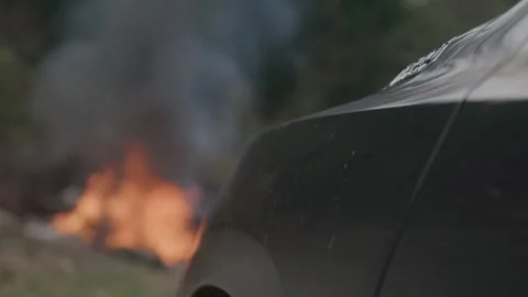 Vehicle Next To Fire Burning in Background Stock Footage 270394812