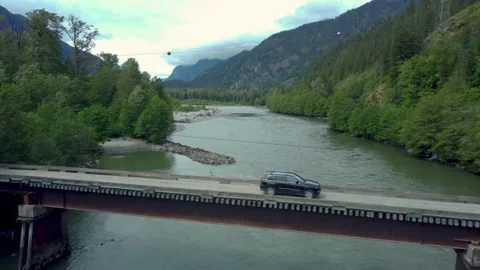 Vehicle Passes Over Bridge - Squamish River in British Columbia Stock Footage 196753339