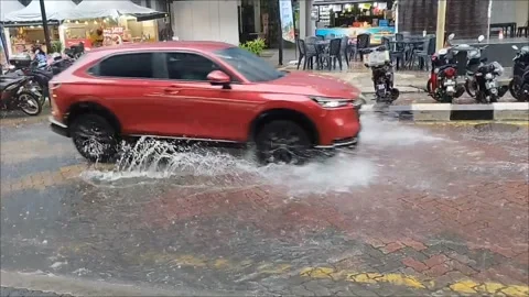 Vehicle passing through a puddle on the road Stock Footage 312331361