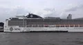 Vehicle shot along riverside of cruise ship MSC Magnifica in Hamburg harbour HD Footage