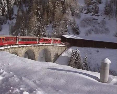 Vehicle shot - train across curved viaduct and disappears into tunnel Stock Footage 45573268
