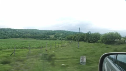Vehicle Side Mirror View Panning Past Rural Green Valleys and Hills Vídeo Stock 338277867