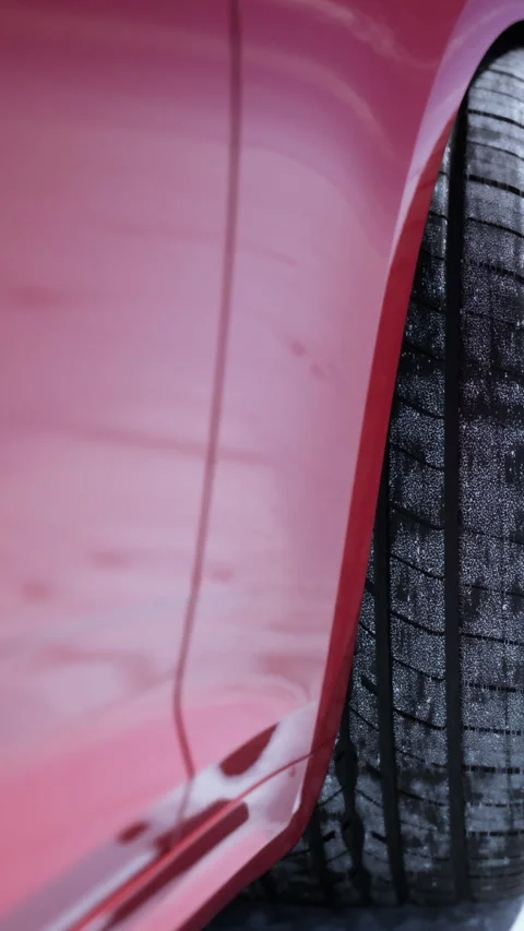 Vehicle with tire showing tread pattern in outdoor setting during daytime Stock Footage 337976303