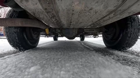 Vehicle tires grip snow while moving forward Stockbeeldmateriaal 334704328