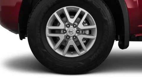Vehicle wheel close up side view Cayenne Red 2020 Nissan Frontier SV 4-Cylinder Stock Footage 159593087