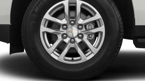 Vehicle wheel close up side view Summit White 2021 Chevrolet Suburban LT Stock Footage 159593186