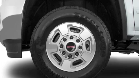 Vehicle wheel close up side view Summit White 2016 GMC Sierra 2500HD SLE Stock Footage 159860849