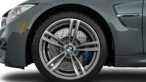 Vehicle wheel close up side view Mineral Gray Metallic 2016 BMW 3-series M3 Stock Footage 159867037