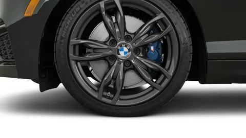 Vehicle wheel close up side view Black Sapphire Metallic 2017 BMW 2-series M240i Stock Footage 159912784