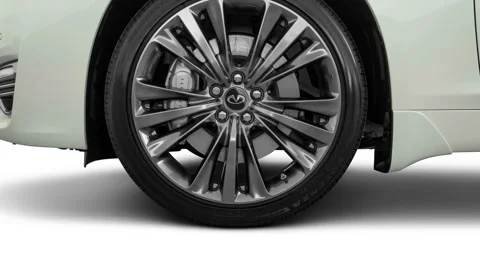 Vehicle wheel close up side view in studio Majestic White 2017 Infiniti Q70L 3.7 Stock Footage 159928977