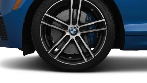 Vehicle wheel close up side view Estoril Blue Metallic 2018 BMW 2-series M240i Stock Footage 159999372