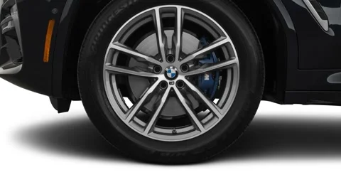 Vehicle wheel close up side view Carbon Black Metallic 2018 BMW X3 M40i Stock Footage 160002989