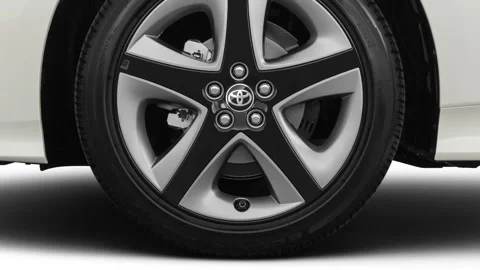 Vehicle wheel close up side view in studio Blizzard Pearl 2019 Toyota Prius XLE Stock Footage 160066907