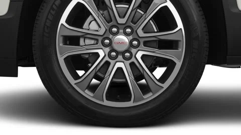 Vehicle wheel close up side view in studio Summit White 2020 GMC Acadia AT4 Stock Footage 160087590