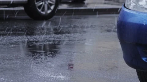 Vehicle wheels drive through the puddle under rain Stock Footage 63116699