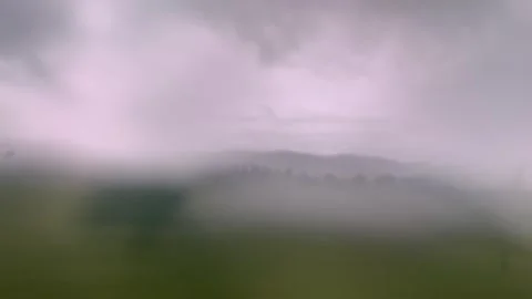 Vehicle Window View of Scenic Landscape Evoking Nostalgia and Reflection Stock Footage 339095797