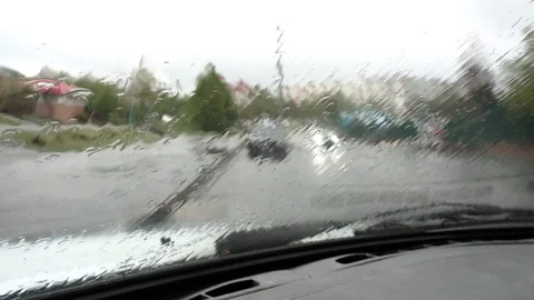 Vehicle wipers clean the windshield from rain drops Stock Footage 129188409